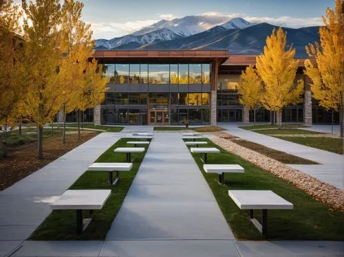 MSU Bozeman Architecture, modern building, Montana State University, Bozeman campus, mountainous backdrop, grandeur entrance, glass facade, steel structure, stone walls, rectangular shape, sloping roo