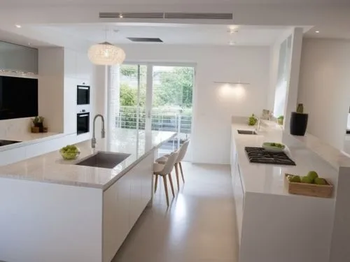 A kitchen design featuring only smooth, handleless cabinet fronts in pure white color. The cabinets have clean, modern lines, creating a minimalist and sleek aesthetic. The overall feel is one of orde