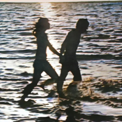 a couple walking into the ocean while holding hands,walk with the children,walk on water,children playing,walk on the beach,baner,toddler walking by the water