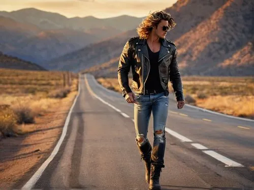 young adult, muscular man, free spirit, wind-blown hair, aviator sunglasses, leather jacket, ripped jeans, black boots, backpack, guitar, highway, open road, sunset, mountain range, distant trees, few