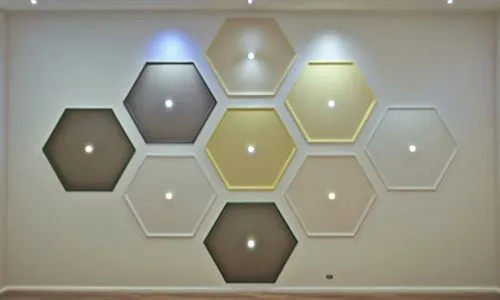 

I want the hexagonal sector to appear lower than the ceiling level of the room.,a room filled with different colored hexagons on a wall,plafond,wall lamp,wall decoration,circle shape frame,velux,cei