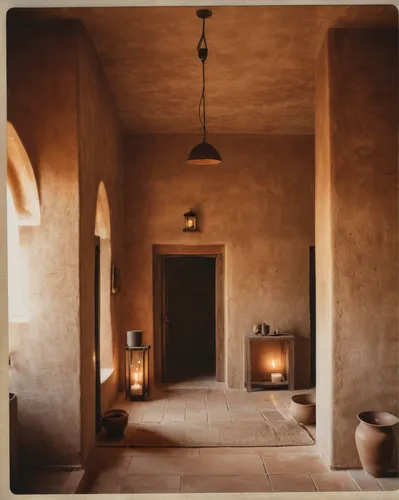 a villa in south africa, hotel room, inspired by Riad Beyrouti, unsplash contest winner, warm lighting, mesa setting, muted brown and beige, tall entry, rammed earth tones, natural candle lighting, so