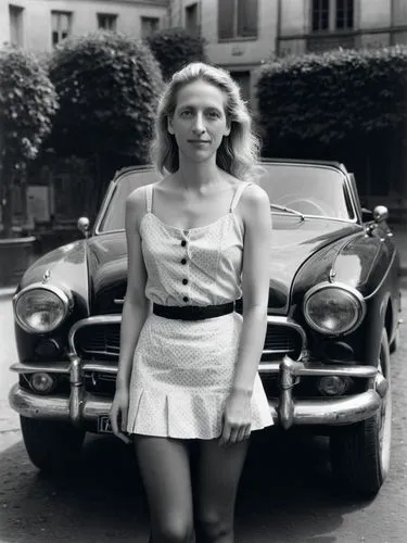 A high resolution photo Portrait of Alice Weidel,a woman standing in front of a vintage car,girl and car,aronde,giulietta,eva saint marie-hollywood,doisneau,auto union,Photography,Black and white phot