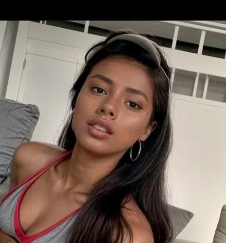 She is lying at home on the sofa.  Lazy lying position.  She wears gray shorts and a shirt.,uhura,filipina,filipino,liliyana,nahri,leilani,colombiana,tiarra,trinidadian,mugdha,malaika,matangi,panamani