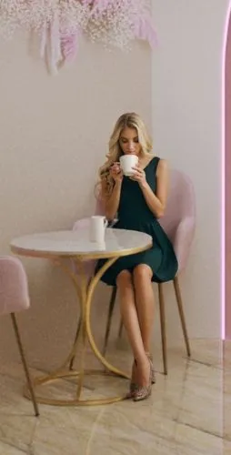 девушка пьет кофе, блондинка в платье,a woman sitting at a table with a cup,pink chair,woman drinking coffee,pink shoes,lyonne,girl with cereal bowl,pink background,cupcake background,sitting on a cha