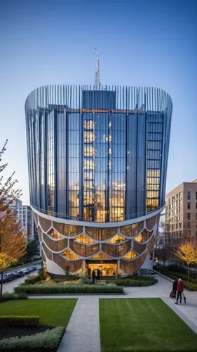 A magnificent building towering above the bustling streets of an urban neighborhood. This architectural marvel features sleek, modern lines and a facade adorned with expansive glass panels that reflec