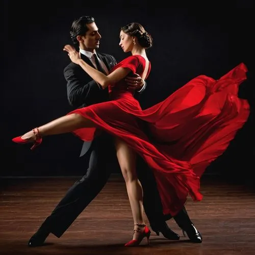 Artistas talentosos. Hermosos jóvenes, hombre y mujer, ejecutando un tango apasionado sobre un fondo negro de estudio. La seda del vestido rojo de la mujer contrasta con el traje negro del hombre, mie