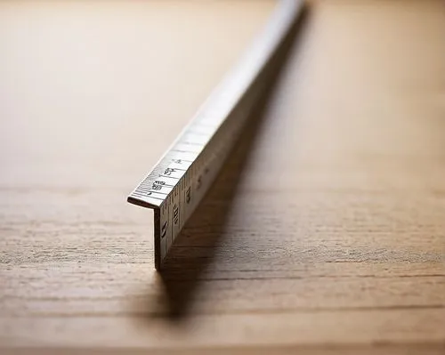 Architectural model, 1/16 scale, wooden ruler, precise markings, silver metal edge, worn handle, slight scratches, detailed texture, studio lighting, shallow depth of field, focus on ruler, blurred ba