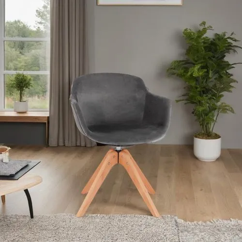 A modern Scandinavian living room interior with a cozy, inviting ambiance, featuring a sleek dark grey velvet chair as the focal point. The room is bathed in natural light from large, floor-to-ceiling