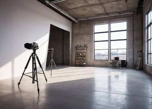 Empty studio, modern minimalist interior, white walls, polished concrete floor, high ceiling, large windows, natural light pouring in, sleek black lines, geometric shapes, metallic accents, industrial