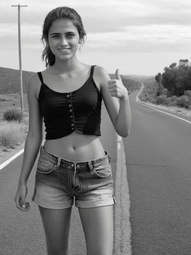 B&W high res photo: A poor-looking young woman stands at the side of the road with her thumb up, hitchhiking.,a woman is holding her hands up in front of a road,hitchhiking,hitchhike,hitchhiked,hitchh