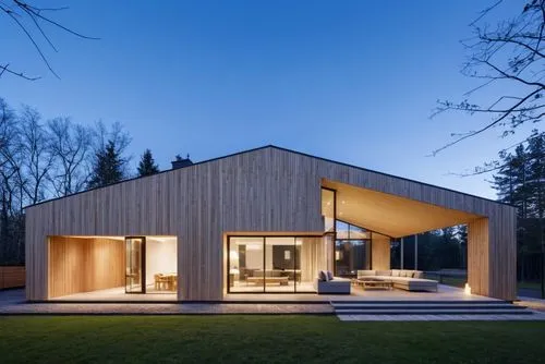  modern 
barnhouse, black and wood, interior items inside, outdoor furniture on the terrace, the area in front of the house is paved with slabs, realism, evening, front  view,Barn house in the evening