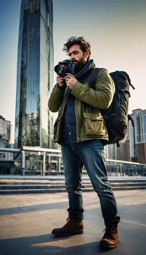 Male photographer, 30s, rugged beard, messy hair, worn denim jeans, black leather boots, olive green jacket, camera equipment, DSLR camera, lens, tripod, backpack, urban landscape, modern skyscraper, 