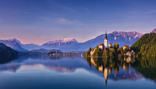 View towards Lake Bled in Slovenia at dawn with Bled Island and the Pilgrimage Church of the Assumption of Mary with the Julian Alps in the background,lake misurina,lake bled,lake lucerne region,slove