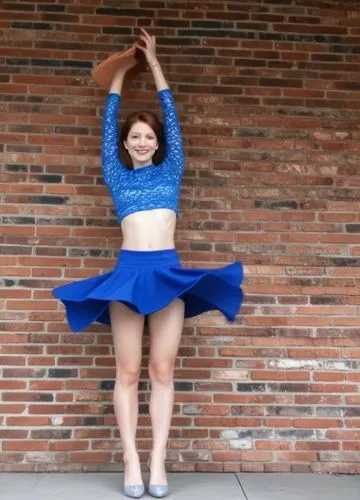 a girl is standing in front of a brick wall,cartwheel,cartwheels,cartwheeling,girl upside down,handspring,handsprings