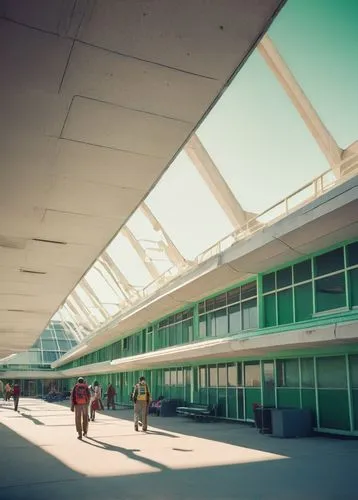 Modern university, NDSU architecture program, campus building, Brutalist style, concrete structure, large windows, angular lines, green roof, solar panels, students walking, backpacks, laptops, notebo