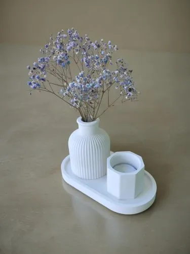 a white ceramic vase on tray holding a bouquet of flowers,porcelain tea cup,butter dish,teacup arrangement,fragrance teapot,gypsophila,flower vase