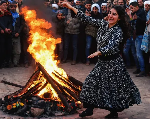 A Kurdish woman dances in front of a Newroz fire in Diyarbakir in March 2017. Photo: Bulent Kilic/AFP,iranian nowruz,zoroastrian novruz,novruz,nowruz,kurdistan,turkish culture,iranian,village festival