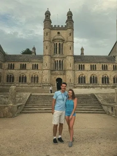 man and woman posing in front of an ancient building,two people standing in front of an old building,abbaye de belloc,hotel de cluny,vesselin,royaumont,abbaye,chenonceau,Photography,Black and white ph