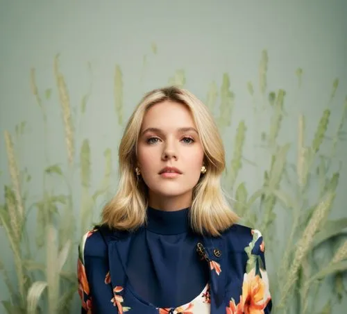 beautiful blonde girl,a woman wearing a blue shirt sitting in front of a vase of flowers,florrie,risberg,mcmorrow,floral,marimekko,lapsley,Photography,Documentary Photography,Documentary Photography 0