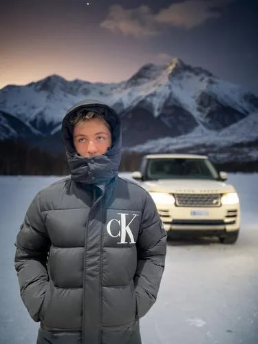 İn front of a Range Rover Car at winter night.,the guy in the jacket stands in the snow front of a car,koyukon,skoki,kavkaz,winterkorn,ski mask,skiwear