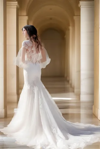 a woman in a wedding dress walking along a hall,bridal gown,wedding photography,wedding dresses,wedding gown,bridal dress,sposa