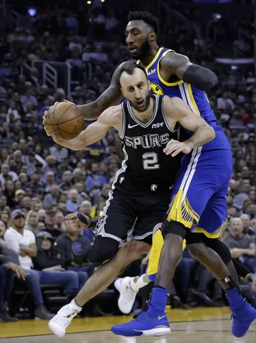 San Antonio Spurs guard Manu Ginobili (20) is fouled by Golden State Warriors center Jordan Bell (2) during the first half of an NBA game, Monday, March 19, 2018, in San Antonio. (AP Photo/Ronald Cort