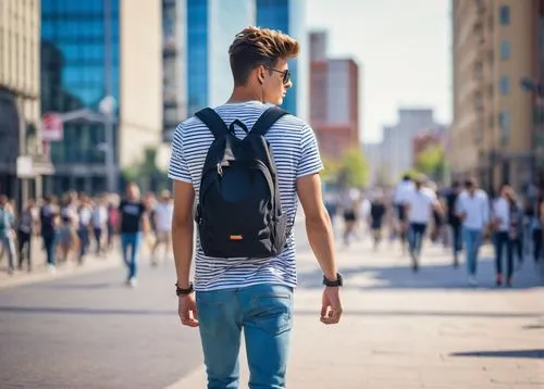 Chic ago boy, young, trendy hair, bold eyebrows, casual wear, graphic T-shirt, skinny jeans, white sneakers, backpack, walking, city street, skyscraper, sunny day, clear blue sky, soft focus, shallow 