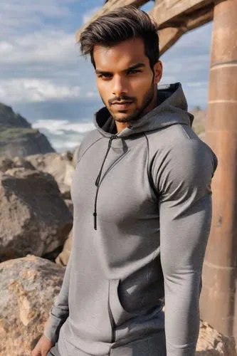 a man standing next to some rocks on the beach,ramcharan,varun,tusshar,reshammiya,purab,kunal,seenu,paswan,shanmuganathan,sreenivas,karan,shahid,devarakonda,himesh,aadhi,emraan,udwan,parupalli,bijlani