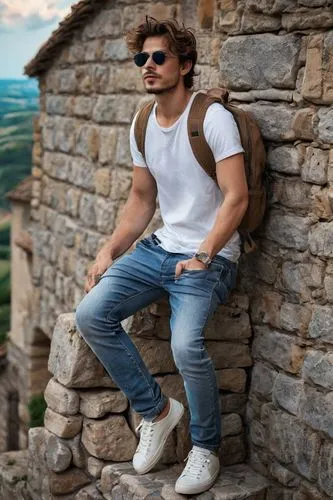 backpacking, young adult, male, casual, rugged, worn-out sneakers, faded jeans, plain white T-shirt, weathered backpack, messy brown hair, stubble, sunglasses, scenic European countryside, rolling hil