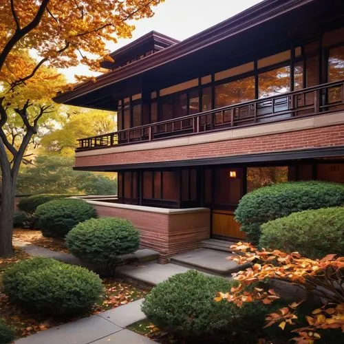 Frank Lloyd Wright's Robie House, Prairie School style, 20th century architecture, horizontal lines, long overhanging eaves, low-pitched roof, rectangular massing, brick and limestone exterior, ornate