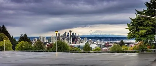 Seattle cityscape, modern skyscraper, glass and steel structure, sleek lines, geometric shapes, urban landscape, Space Needle in the distance, Mount Rainier backdrop, cloudy sky, afternoon light, warm