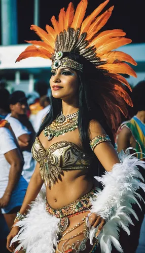 A woman dressed as India with a feather costume and a feather on her heel at the Rio de Janeiro carnival,brazil carnival,maracatu,peruvian women,sinulog dancer,chiapas,peru i,pachamanca,paraguayian gu