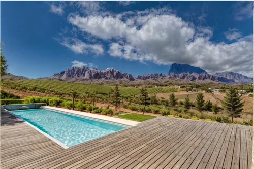 wooden decking,catarpe valley,roof landscape,drakensberg mountains,holiday villa,panoramic landscape,outdoor pool,south africa,chalet,house in mountains,house in the mountains,luxury property,the bale