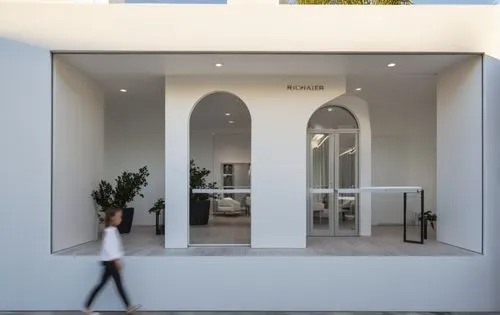 SHOPFRONT ELEVATION, HAIR SALON, DISPLAY GLASS, WHITE PAINT, WHITE WOOD RIPS, ARCHES,,a person walking past a store front and palm trees,mirror house,cubic house,house entrance,orangerie,baladiyat,cub