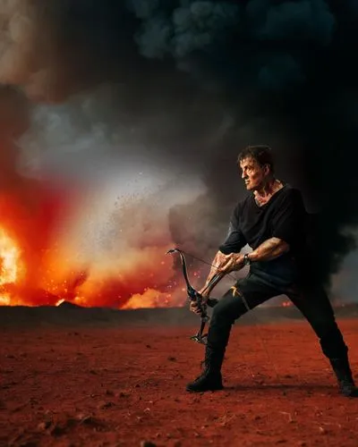 man in wide stance wearing black combat pants and combat boots, compound bow, burning land, fire everywhere on a wide plain, red clouded burning sky, Dante's inferno,deucalion,flamethrower,mad max,gry