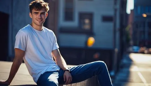 random guy, handsome, strong facial features, short brown hair, messy hairstyle, bright blue eyes, thick eyebrows, small nose ring, casual smile, relaxed posture, white T-shirt, dark jeans, sneakers, 