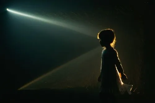 Silhouette of a little girl walking in the dark, she looks further,
A beam of light starts from her face and slowly becomes a bigger and bigger light.,abduction,spotlight,beam of light,the light,flash