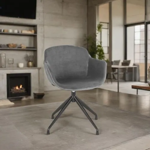 A stylish, modern loft with an industrial aesthetic, featuring a sleek gray velvet chair as the centerpiece. The space is bathed in natural light from large, floor-to-ceiling panoramic windows, offeri