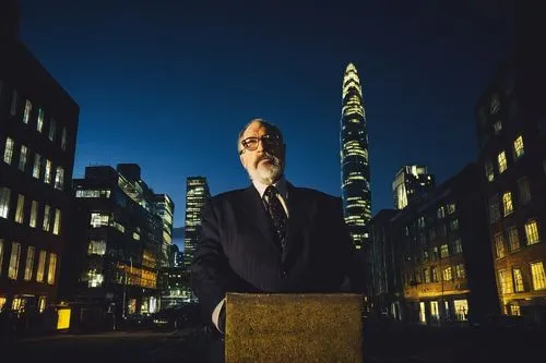 David Malman, mature man, 50yo, beard, glasses, suit, tie, hands behind back, standing, architectural model, modern building, skyscraper, cityscape, nighttime, dark blue tone, warm yellow light, drama