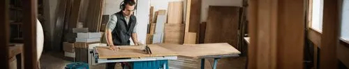 a man standing on the counter in a shop,cabinetmaking,cabinetmaker,cabinetmakers,frame drawing,joinery,containerboard