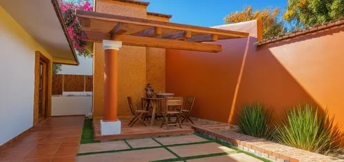 REMODELACION DE UNA CASA CON ESTILO MEXICANO, USO DE COLORES VIVOS, MADERA, PISOS DE BARRO, FLORES Y UN ESPEJO DE AGUA CON FUENTE EN UN MURO,an orange wall in a home with outdoor dining set,casitas,pa