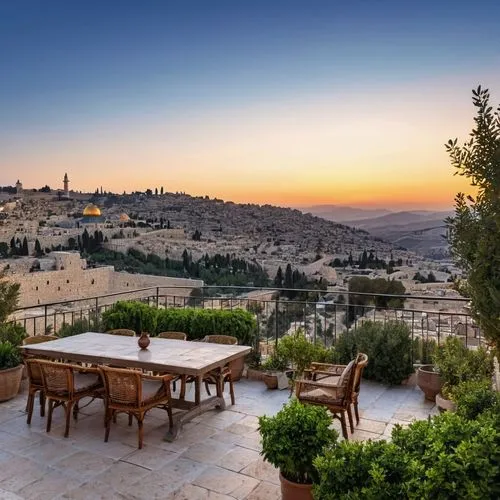 A Jerusalem courtyard overlooking the Jerusalem mountains at sunrise

,a table that is set on a balcony,zejtun,assisi,jerusalem,matera,modica,cortona