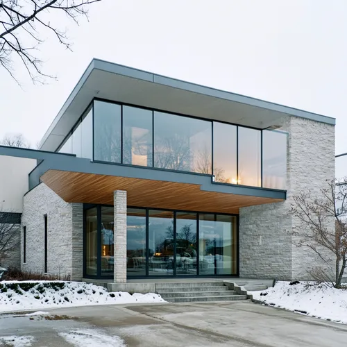 1building,the entrance to a very nice looking building in the snow,modern house,mid century house,chanhassen,glass facade,modern architecture,wayzata,dunes house,structural glass,luxury home,mid centu