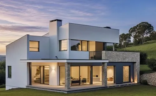 A modern, minimalist white house with clean lines and a few stone accents on the façade. The porch features white beams, complementing the sleek, minimalist design. The house is slightly elevated abov