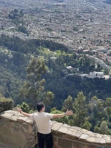 man with arms outstretched on a rocky balcony overlooking a city,rubidoux,ehden,klis,duhok,queretaro,cuernavaca,lycabettus,angeleno,guanajuato,above the city,cahuenga,pena de bernal,granada,altadena,b