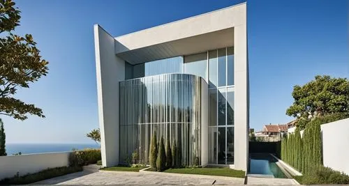 The modern house gleams in the sunlight, its sleek glass facade reflecting the soft light of the setting sun. Beneath its glass-covered facade, a serene garden path leads the way, leading to a grand m