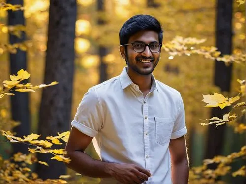 Young Indian man, Vishnu Prasad, 25 years old, strong facial features, black hair, short beard, brown eyes, glasses, casual wear, white shirt, dark blue jeans, sneakers, standing, relaxed posture, han