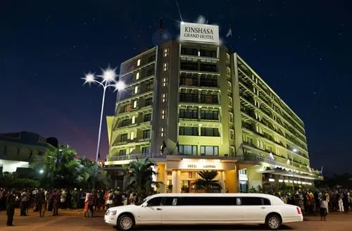 The hotel is in Africa. A limousine is parking in front of the hotel, where a huge crowd of African people is waiting outside. There is the press, there are photographers from African magazines. They 