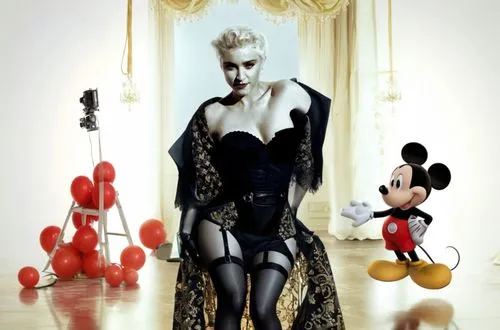 Madonna is on a movie set with Mickey Mouse in her arms!  Madonna is wearing a sexy dress and has beautiful legs. The movie set is full of crew members such as: director, camera operator, sound contro